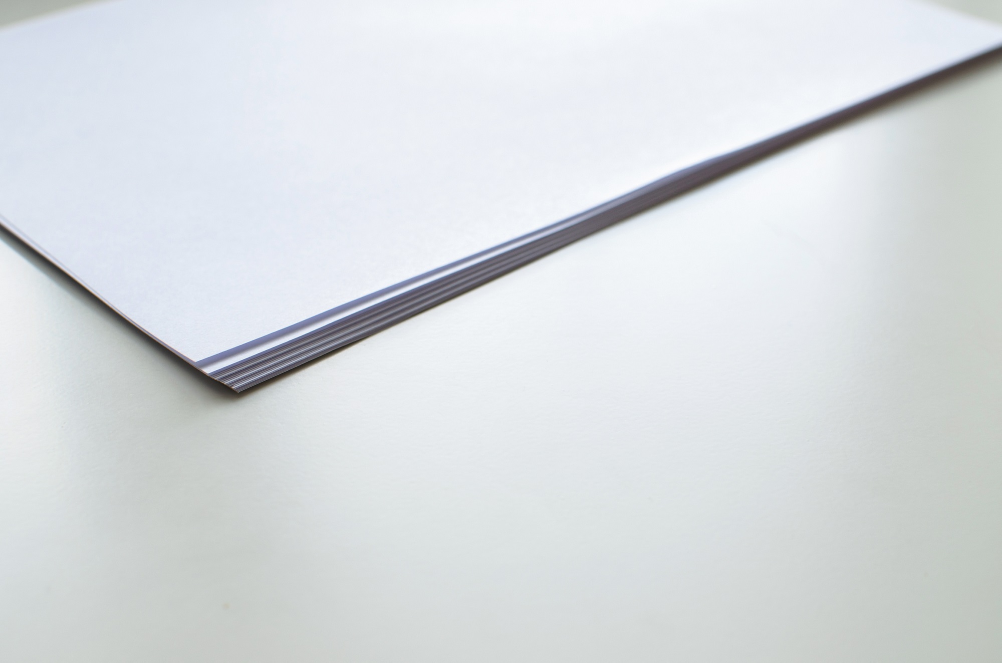 Legal documents stacked on a desk in a law office environment.