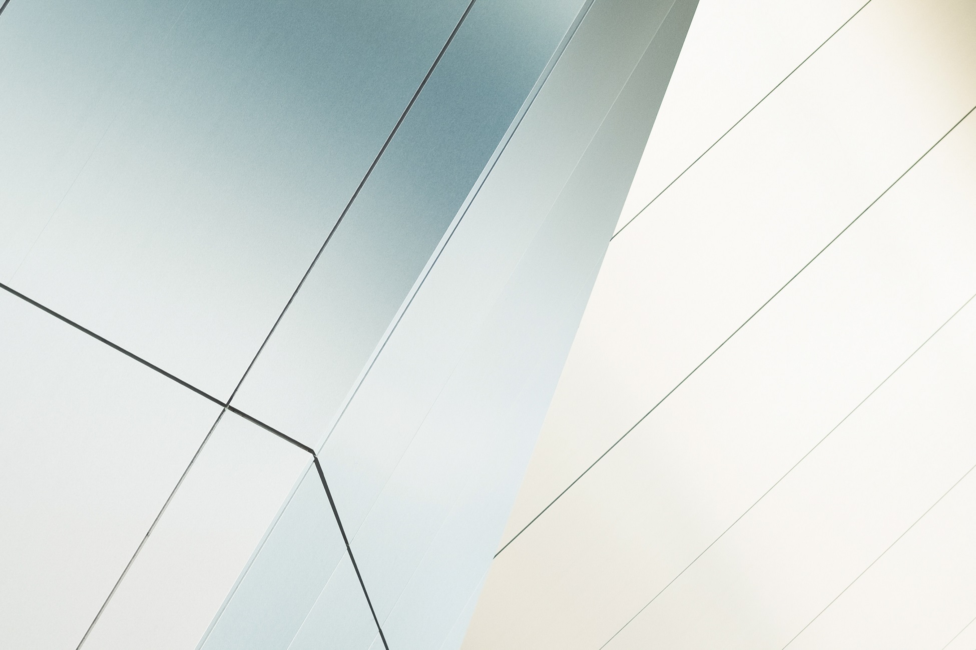 Abstract angles and patterns of metallic surface in a modern architectural setting.