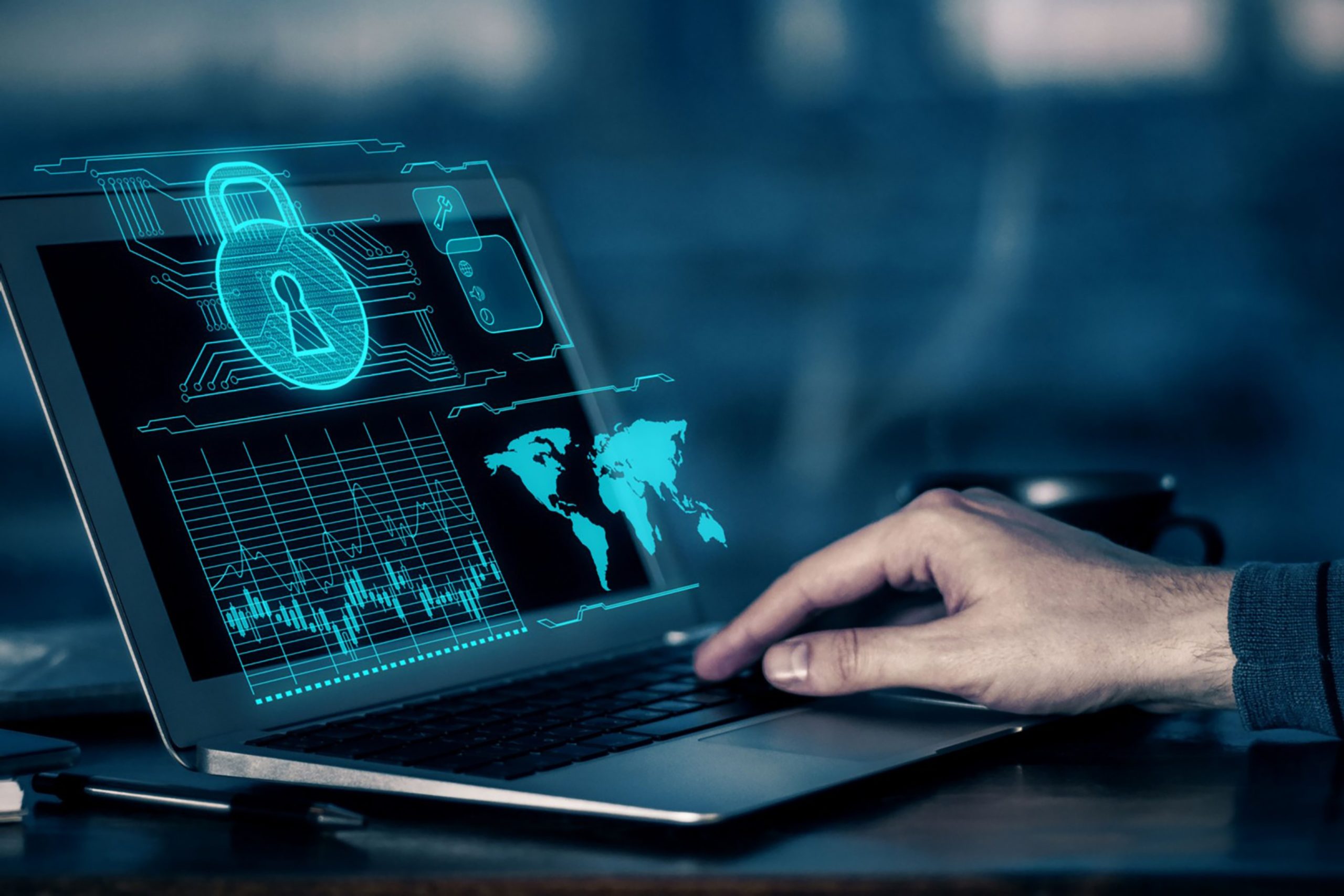 Hand engaging with a laptop displaying cybersecurity graphics and data analytics.