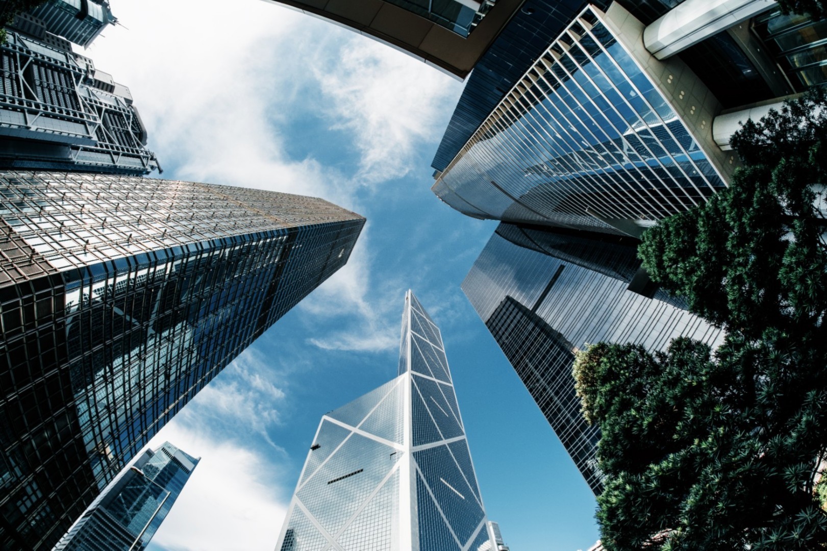 Modern skyscrapers with reflective glass facades under a clear blue sky. Urban legal district setting.