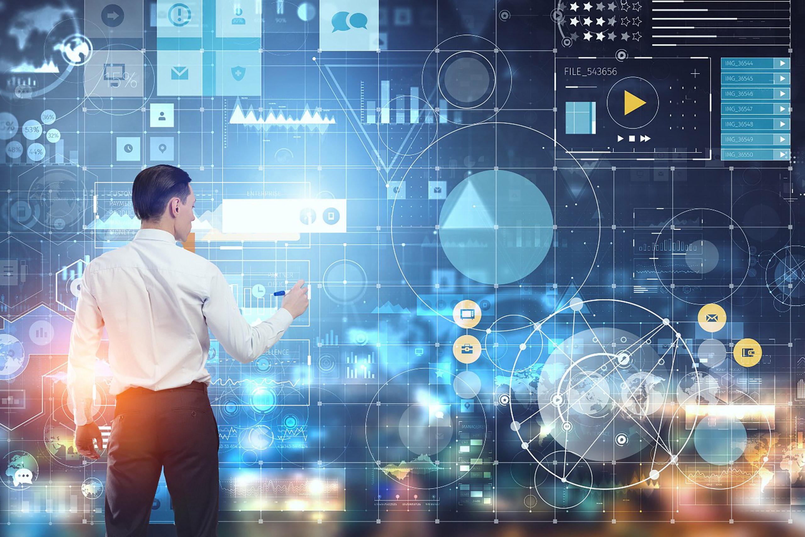 Professional analyzing digital data on a screen with charts and graphs in a modern workspace.