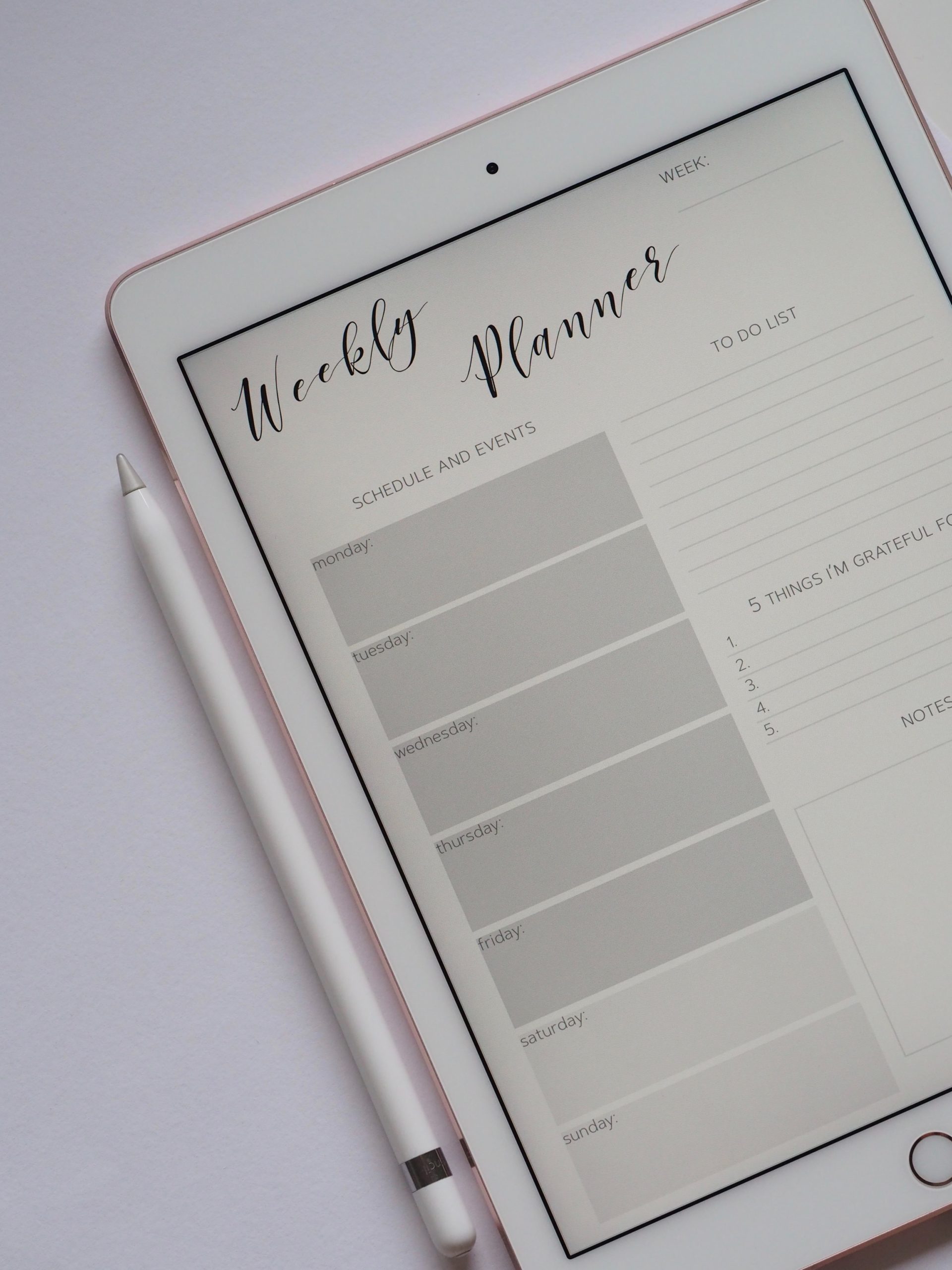 Weekly planner displayed on tablet with sections for schedule, to-do list, and gratitude notes.
