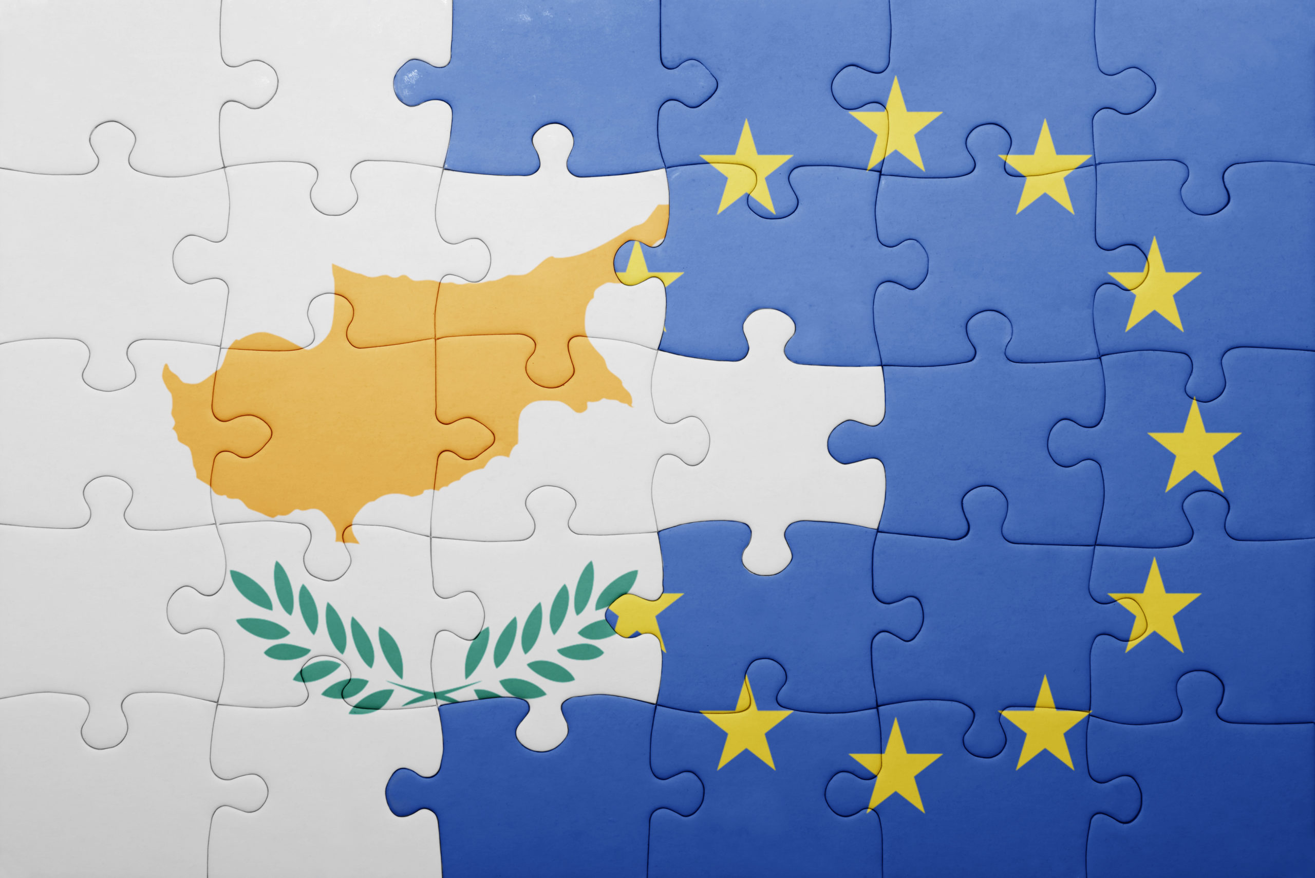 Puzzle pieces depicting the flags of Cyprus and the European Union blended together.