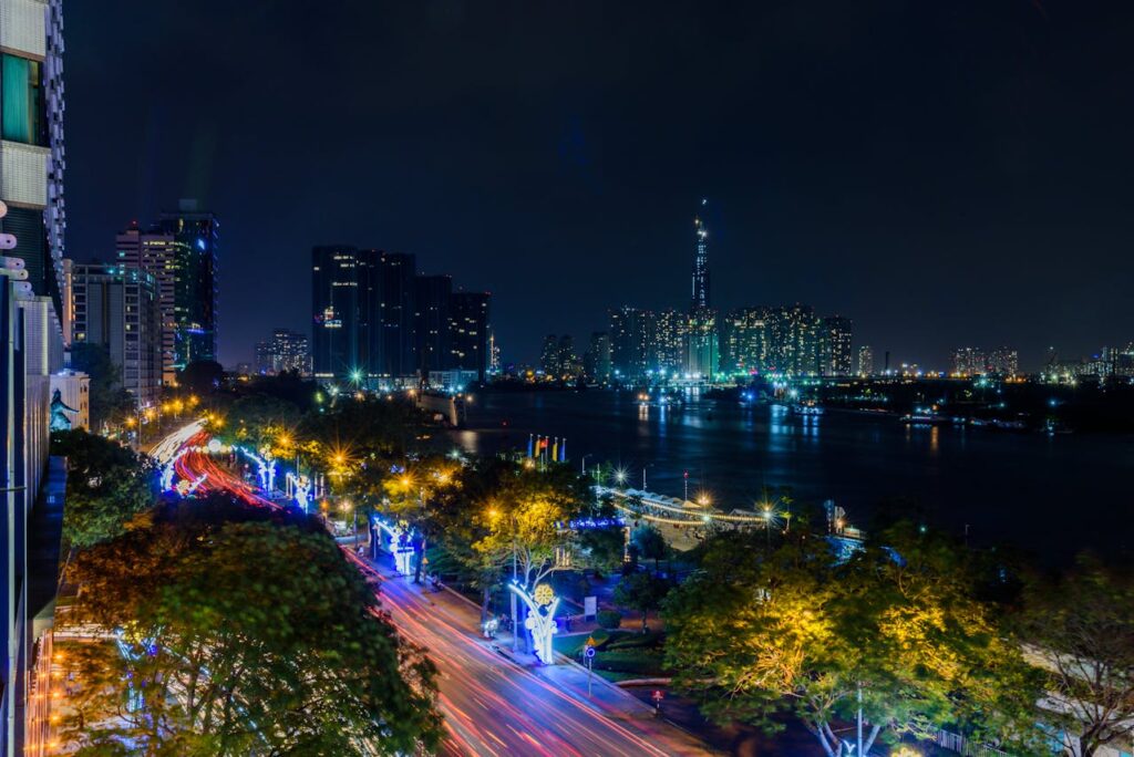 a city with lights and trees and a body of water Law on Enterprises | GLE News