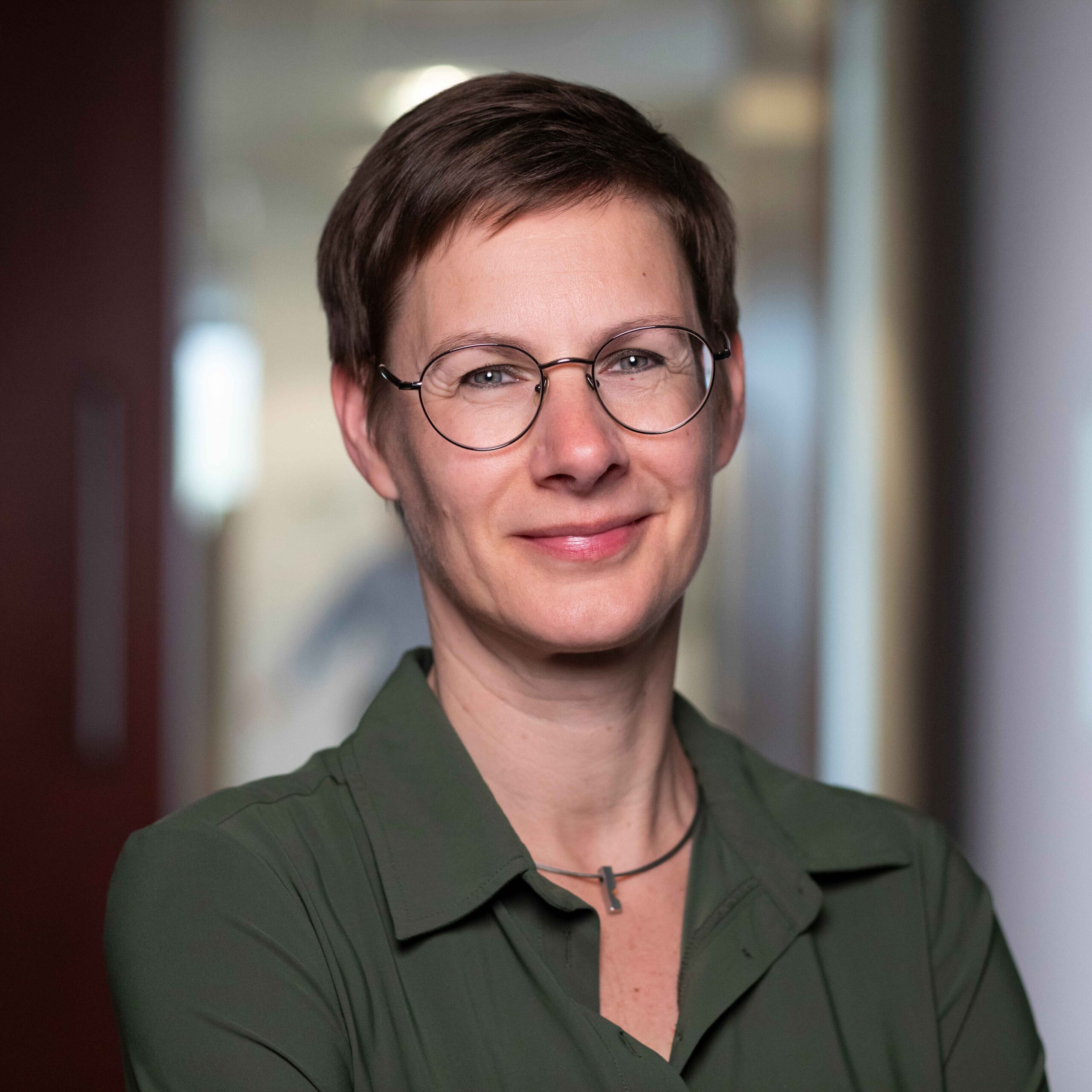 Legal professional smiling confidently in an office setting with modern decor.
