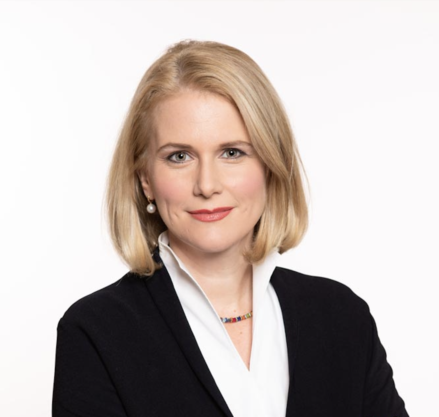 Female attorney wearing a black jacket, with shoulder-length blonde hair and a neutral expression.