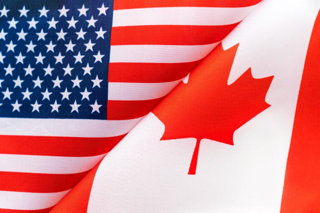 Home - Canadian And American Flags Folded And Beside Each Other - Global Law Experts