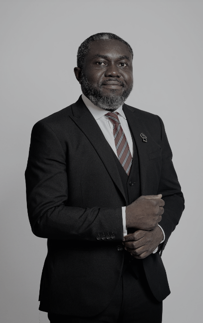 Lawyer In A Suit With A Serious Expression, Standing Confidently Against A Neutral Background.