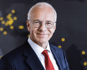 Lawyer smiling confidently in a pinstripe suit against a blurred background with abstract lights.