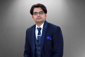 Lawyer in formal attire sitting against a neutral background.
