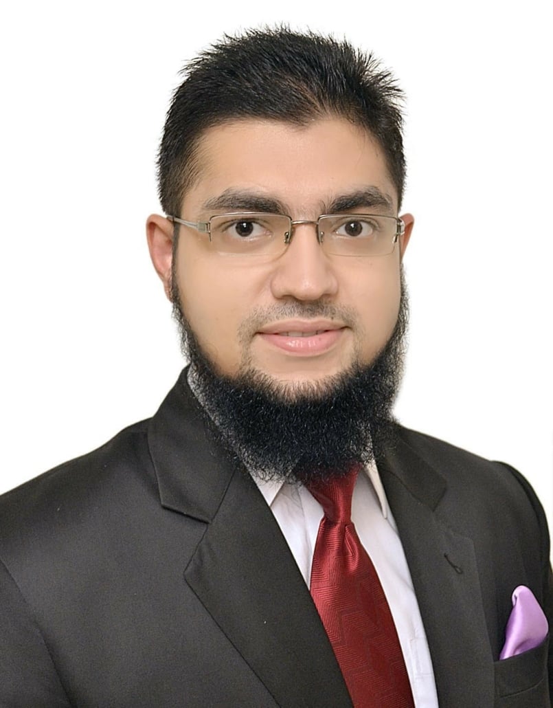 Lawyer in formal attire with glasses and a beard, posing for a professional headshot.