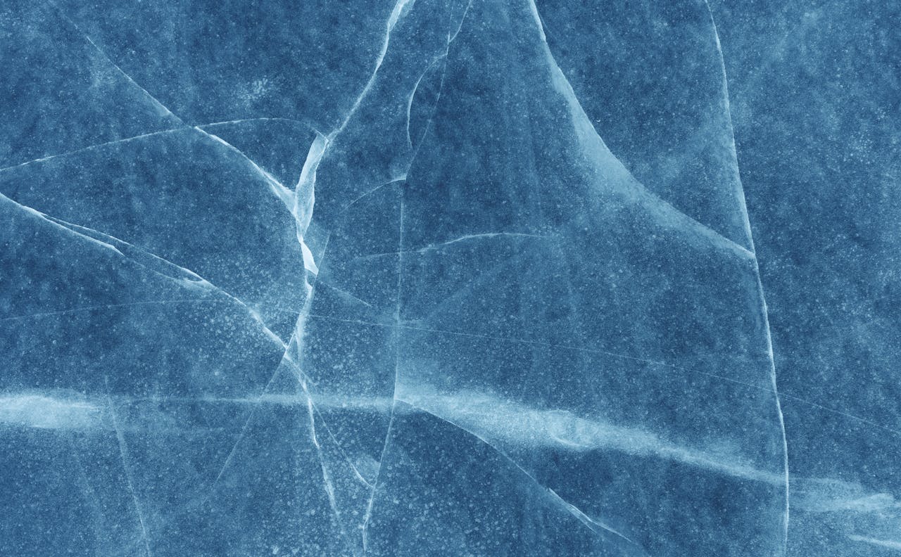 Abstract blue stone texture with visible cracks and patterns.