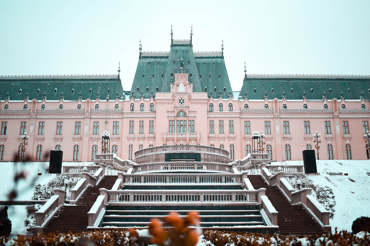 Historic building facade with intricate architecture, steps, and snow-covered surroundings.