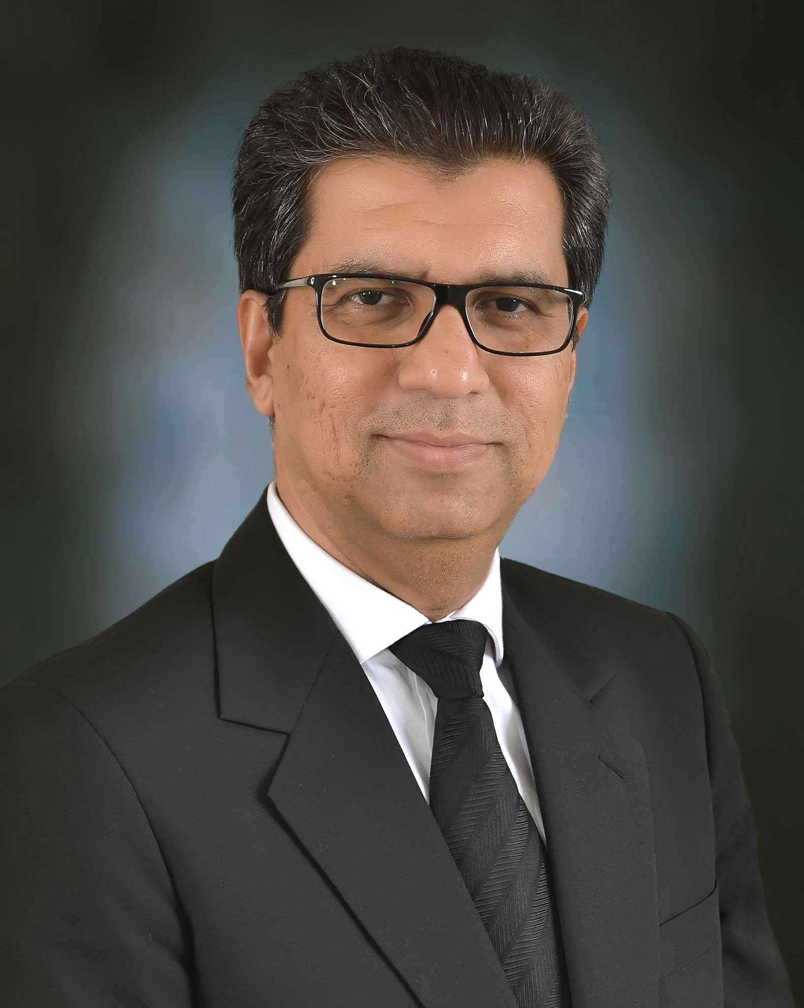 Attorney in formal attire, posing for a professional portrait against a neutral background.