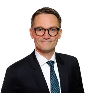 Attorney posing for professional headshot, wearing a suit and tie, with a neutral expression.