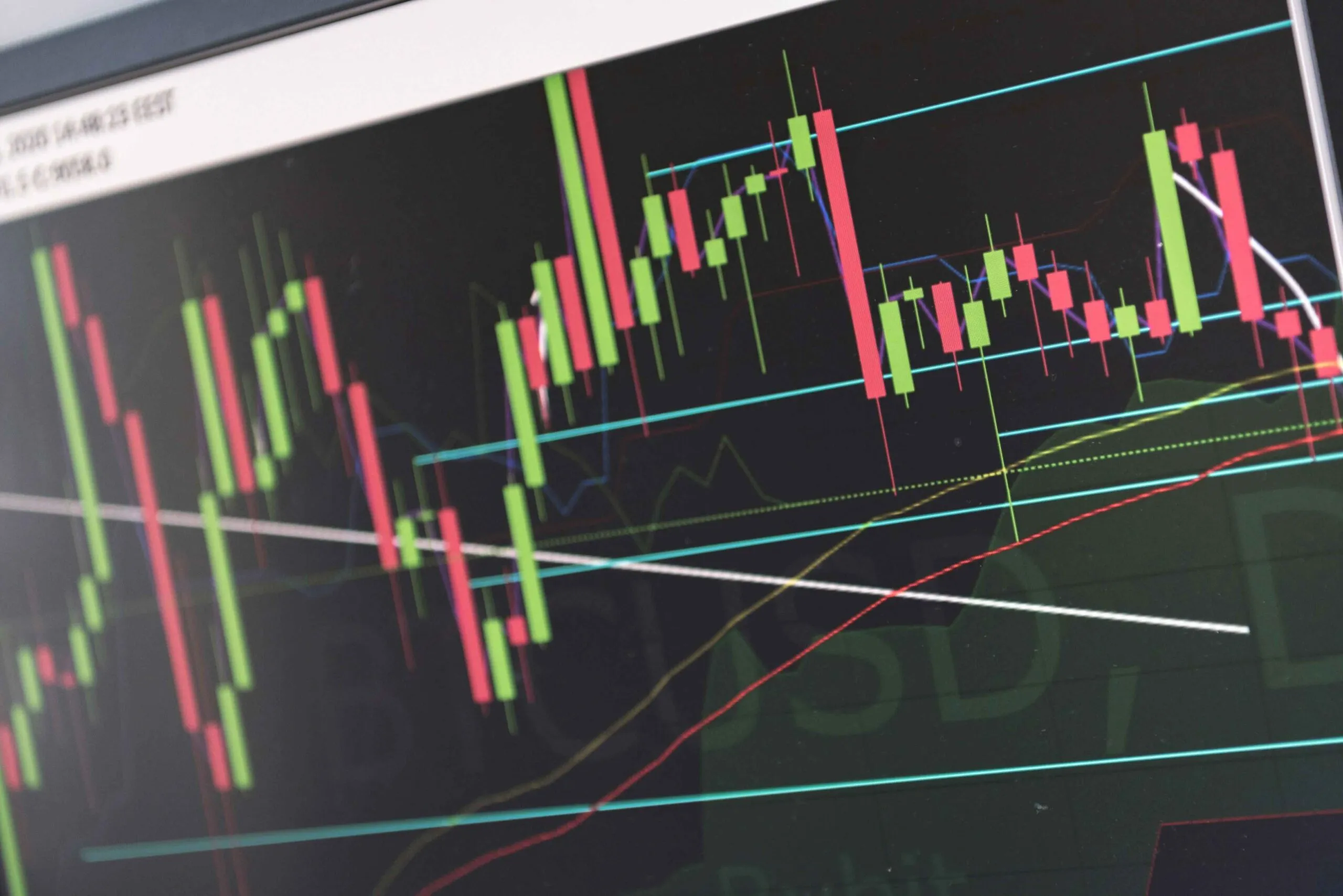 Stock market chart displaying price fluctuations with candlestick patterns in green, red, and black on a dark background.