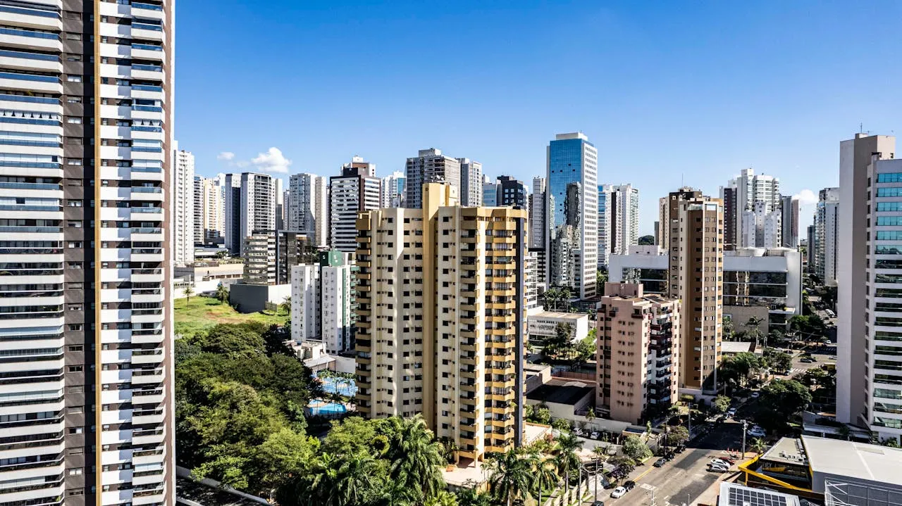 City skyline featuring modern high-rise buildings and greenery in urban landscape.