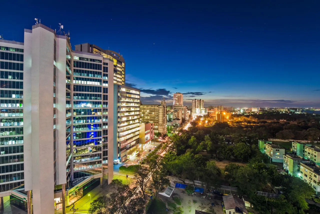 Modern skyline featuring commercial buildings and city lights at dusk, indicating an urban legal environment.