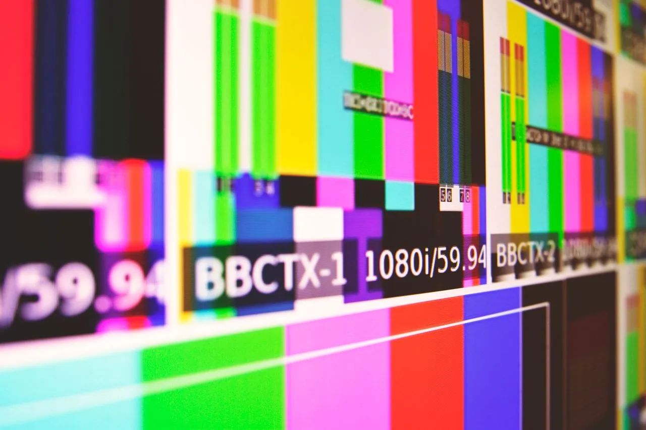 Colorful technical display featuring video signal indicators and resolution information.