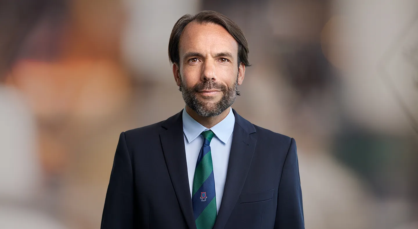 Attorney posing in professional attire against a neutral background.